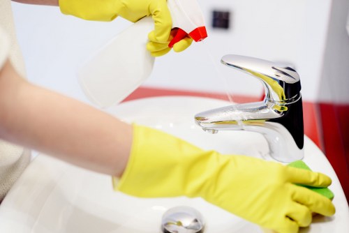 Cleaner working on a built-in oven in a Mayfair property